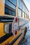 Parked yellow school bus with focus on retracted stop sign