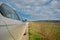 Parking of a car on gravel road and magnificent green grass near the road