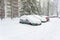 Parking cars covered by a lot of snow