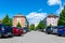 Parking cars near old apartment buidings on a sunny day.