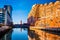 Parking garage and apartment building reflecting in water at the