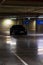 Parking garage interior with a few parked cars. Underground parking garage in Bucharest, Romania, 2021