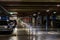 Parking garage interior with a few parked cars. Underground parking garage in Bucharest, Romania, 2021