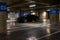 Parking garage interior with a few parked cars. Underground parking garage in Bucharest, Romania, 2021