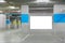 Parking garage underground interior with blank billboard.