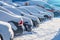 Parking lot with cars sunlit covered in fresh snow