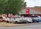 A parking lot with many colourful cars in front of the shop of the Penny Market supermarket chain