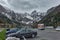 Parking lot and rest area on the Austrian highway with the snowy massif of the Alps behind a highway bridge