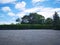 Parking lot sprinkled with gravel on tree bush nature background