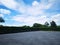 Parking lot sprinkled with gravel on tree bush nature background