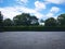 Parking lot sprinkled with gravel on tree bush nature background