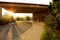 Parking place surrounded by greenery and motorcycles during the sunset