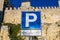 Parking sign for motorbikes, parking road sign for motorcycles in front of a castle wall in San Marino