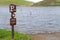 Parking sign pointing to flooded parking lot