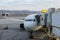 Parking at terminal gate passenger aircraft at the connected bridge is loaded with luggage