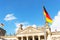 Parliament Reichstag building in Germany Deutschland, Deutscher Bundestag. Flags flying in the wind, blue sky and clouds.