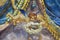 PARMA, ITALY - APRIL 17, 2018: The detail of baroque angels with the floral wreath fresco in church Chiesa di San Bartolomeo