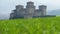 Parma - Italy - castle of Torrechiara through windy meadow vale panorama - Emilia Romagna region