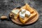 Parmesan. Different types of cheese with knife on a dark background. Cheeses set dor blu chedar camamber brie. place for text, top