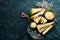 Parmesan. Pieces of Parmesan cheese on black stone background. Top view.