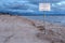 PARNU, ESTONIA - MAY 02, 2015: Sign on the Parnu bay beach with a warning about the possibility of nude people nudists on the