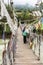 Paro, Bhutan - September 14, 2016: Tourists on the Iron Bridge of Tamchog Lhakhang Monastery, Paro River, Bhutan.