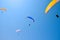 Paroplane group flying against the blue sky.Extreme sports, enjoy life, appreciate the time, tandem paragliding, controlled pilot