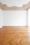 Parquet floor , white walls and stucco ceiling in empty room after renovation