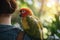 A parrot perched on a woman\\\'s shoulder.