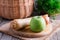 Parsnips with an apple on a wooden cutting board