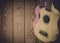 Part of an acoustic guitar on a blue wooden background.