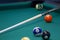 Part of the American pool table with balls and cue