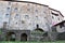 Part of the back of a large and historic stone house in San Romano in Garfagnana with laundry hanging to dry.