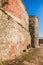 Part of the bastion of an ancient castle. Powerful fortification in the middle of the castle. High ancient walls in the castle.