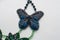 Part of beaded necklace in shape of butterfly on white background. Female accessories, decorative ornaments and jewelry.