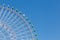 Part of big funfair ferris wheel with clear blue sky