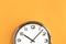 Part of big wall clock on orange background