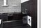 Part of black hardwood kitchen interior