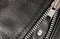 Part black leather clothing with a zipper. macro