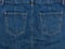 Part of the blue denim skirt. Wooden background, fashionable con