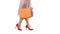 Part body, beautiful female slender legs girl holding a paper shopping bags on white background.
