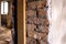 Part of brick doorway on plaster wall.