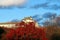 The part of building at Himeji Castle, Looking from out side with red autumn tree and blue sky background.
