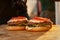 Part of a burger on a wooden board. Street fast food. Sunset light.