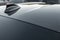 Part of carbon roof of the car. Modern design sport car radio antenna also known as shark fin. Close up carbon fibre car