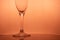 Part of champagne alcohol glass on romantic warm pink background for party or celebration event