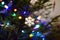 Part of christmas decorating house interior. Branch of xmas fir tree Illuminated garland. Snowflake toy closeup