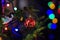 Part of christmas decorating house interior. Branch of xmas fir tree Illuminated garland. Xmas bauble toy closeup