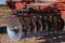 Part of the cultivator, steel, round discs in a row.