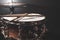 Part of a drum kit, snare drum on a dark background